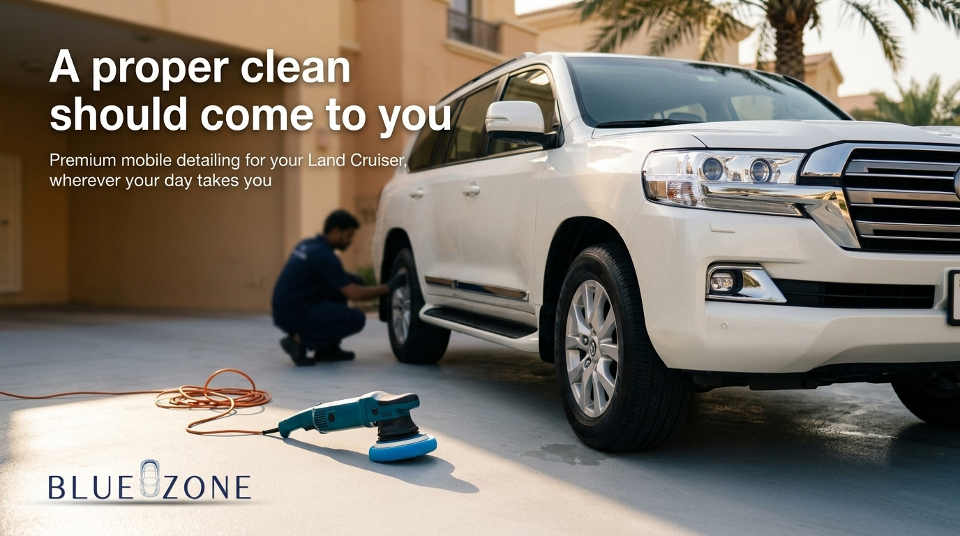Mobile car detailing scene: technician working on a white SUV in a driveway, with a polisher and power cord in the foreground; BlueZone branding visible.
